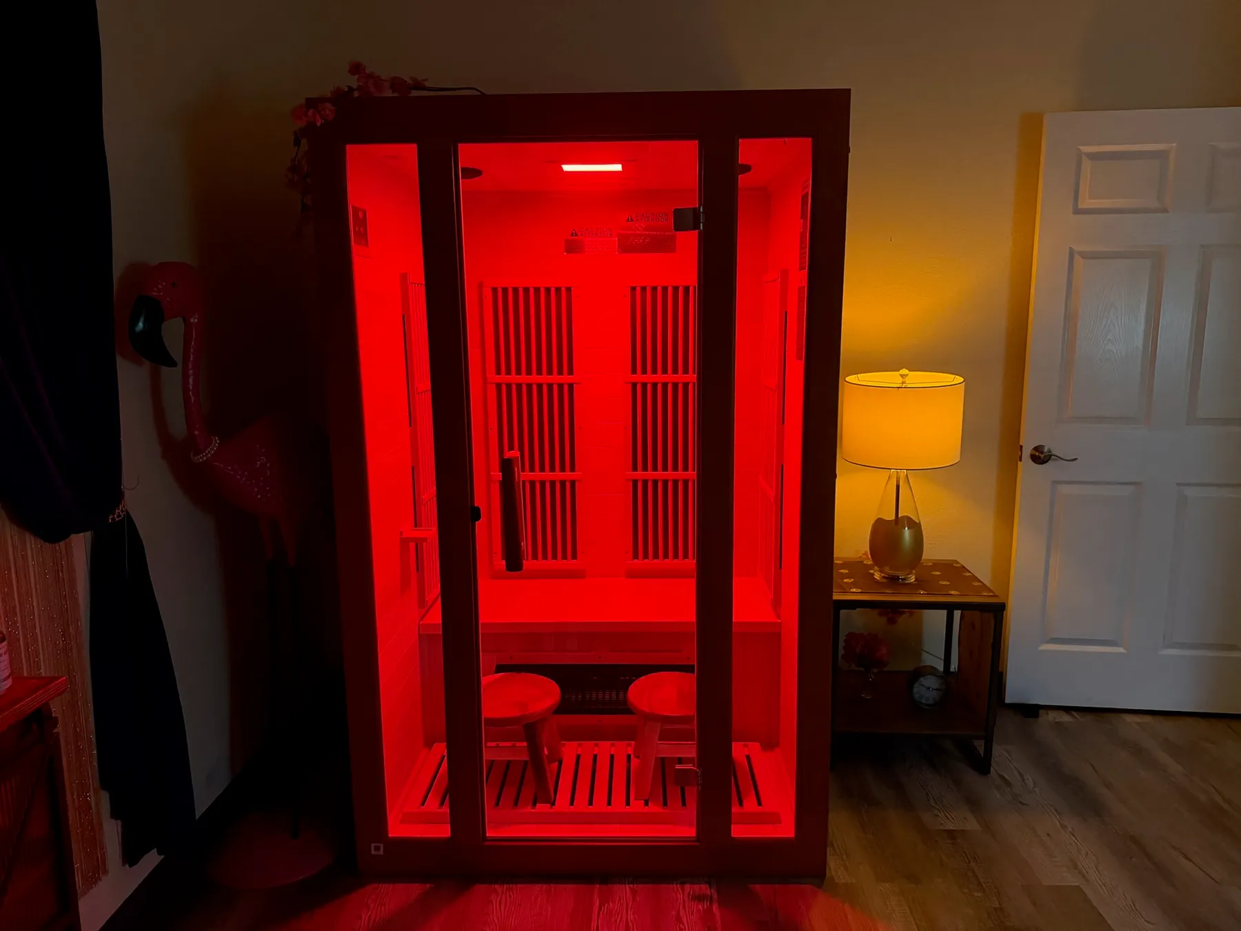 The two-person infrared sauna at Spa O2, lit with red light therapy
